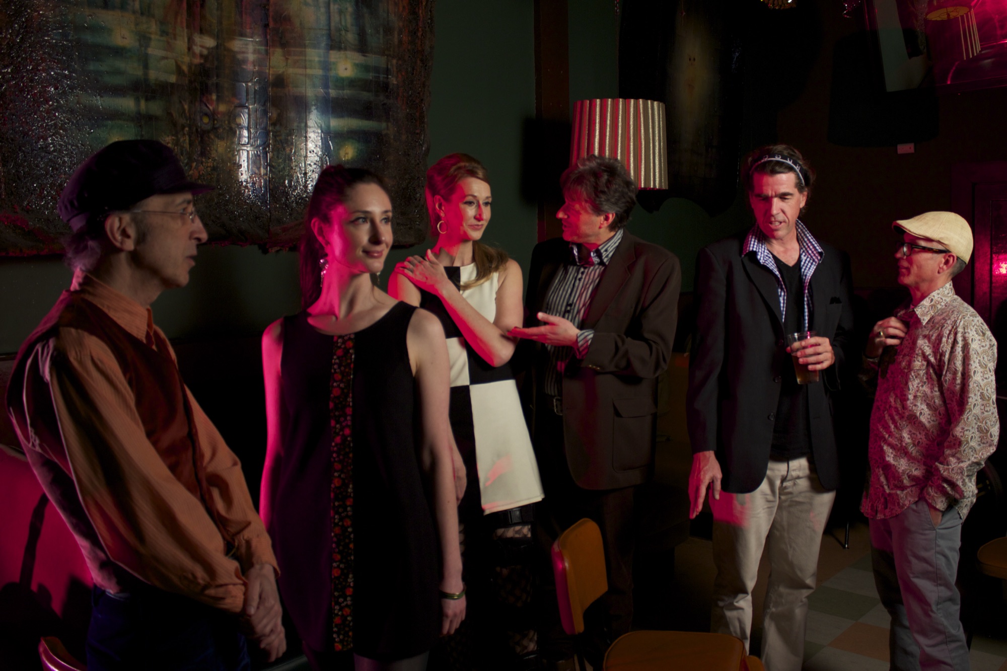 Rue '66 in a dimly lit club, lit in pink and green