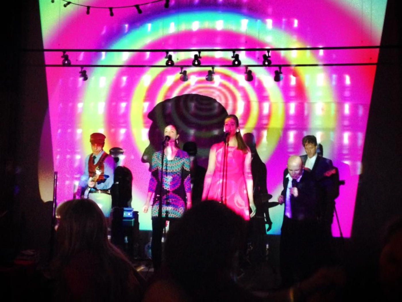 Rue '66 performing in front of a concentric psychedelic projection